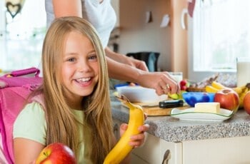 a girl holding a banana